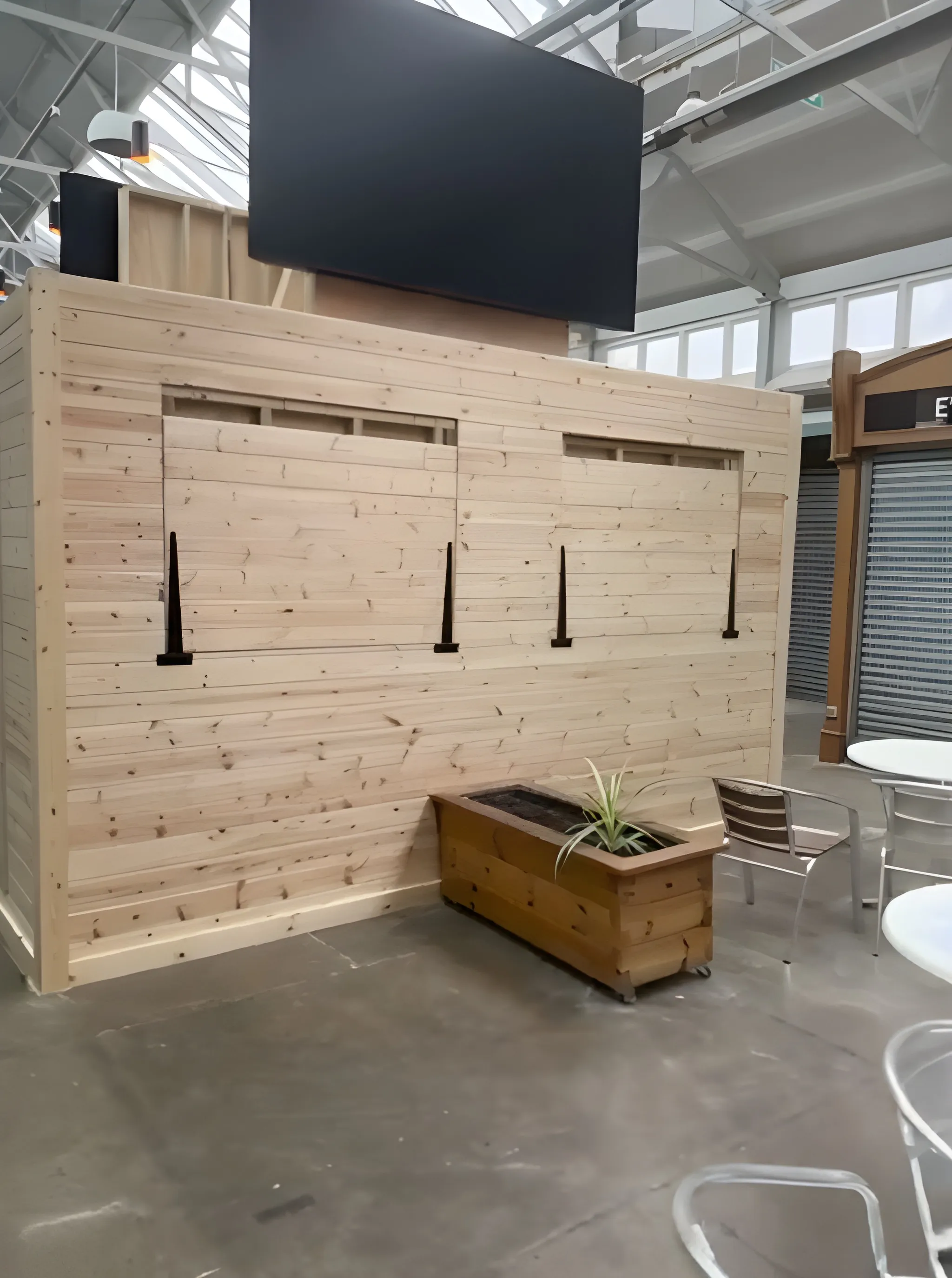 Timber-framed serving hatch and kiosk with fold-down counters, built beneath the glazed roof of Gravesend Borough Market